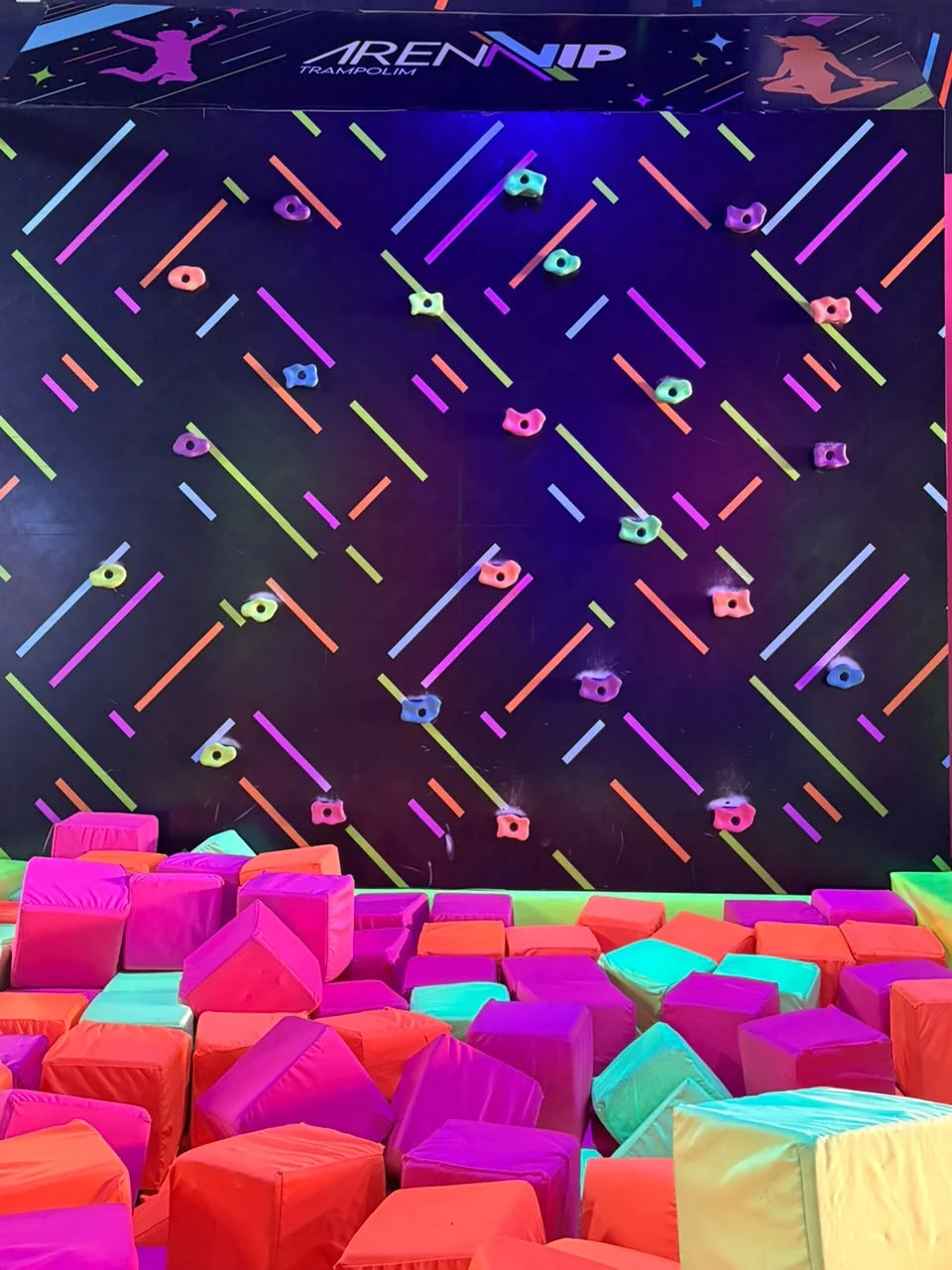 Parede de escalada sobre a piscina de espuma